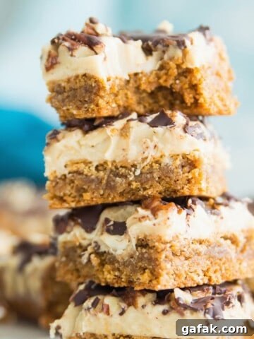 A stack of four turtle cookie bars and the top one has a bite out of it.