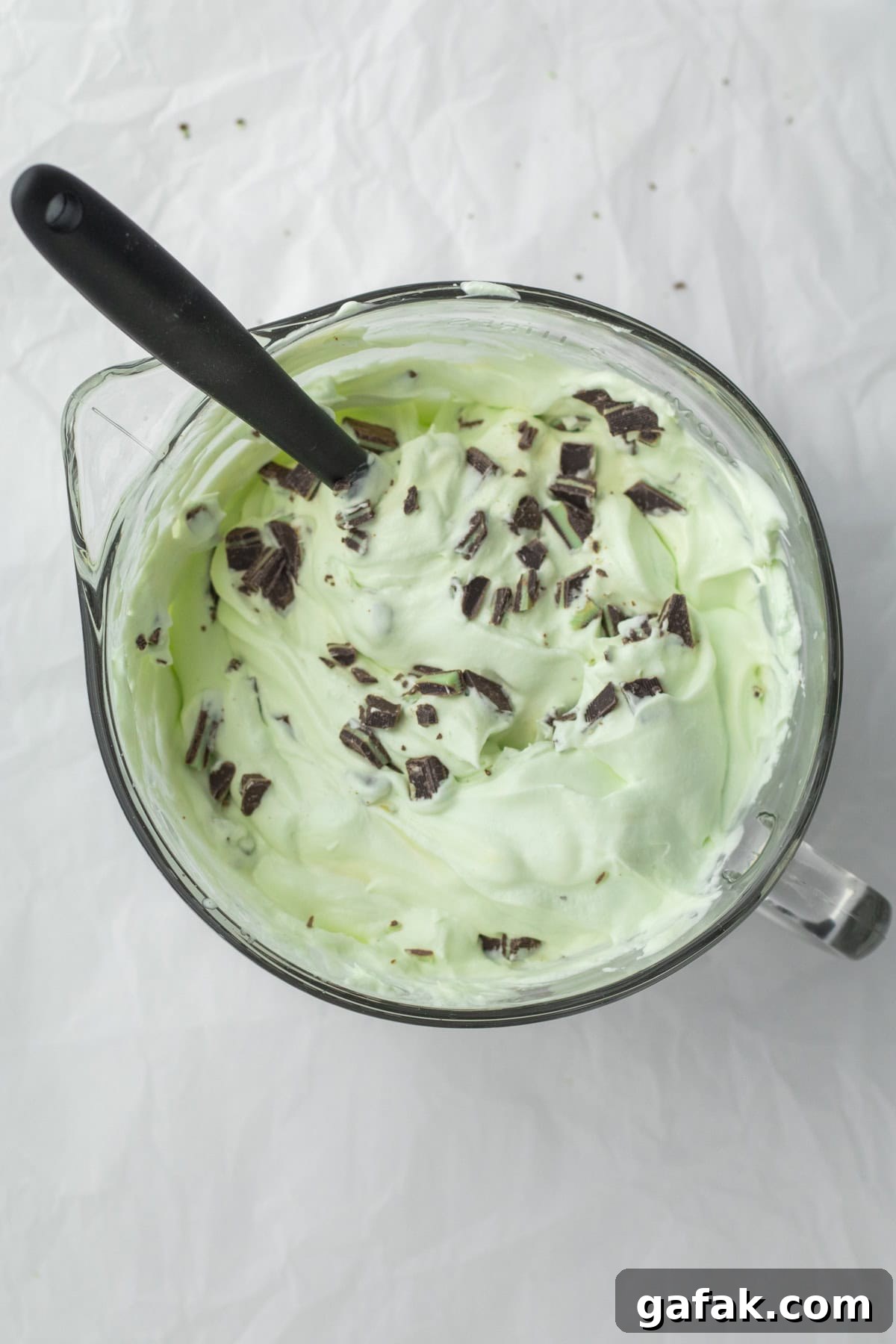 adding chocolate chips to the ice cream base