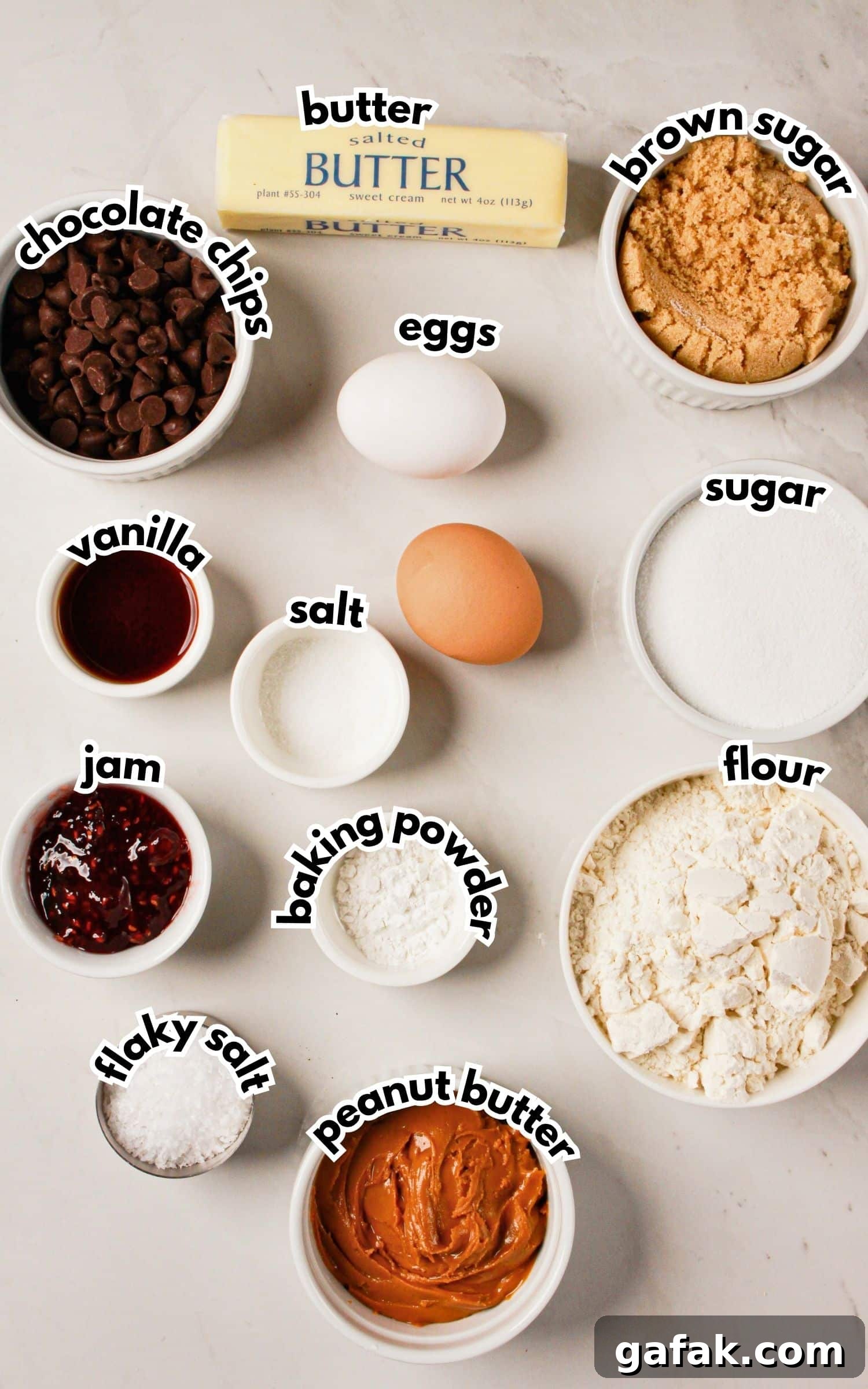 Bowls of ingredients labelled with text on a counter.