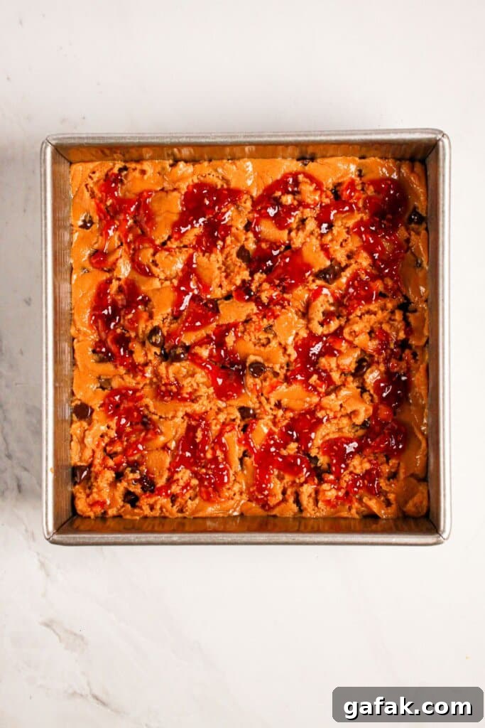 Jam being swirled into batter.