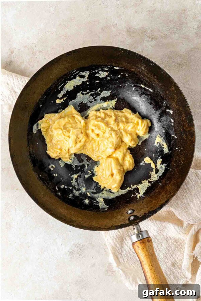 Garlic Prawn Egg Fried Rice Recipe for Quick Weeknight Meals 6 Scrambled egg in a wok.