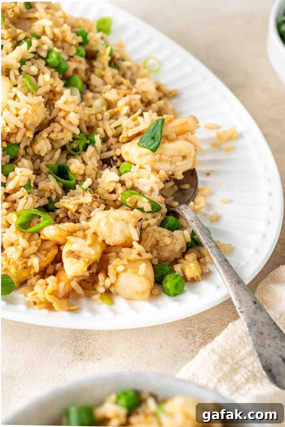 Garlic Prawn Egg Fried Rice Recipe for Quick Weeknight Meals 10 Close up of a spoon serving prawn fried rice.
