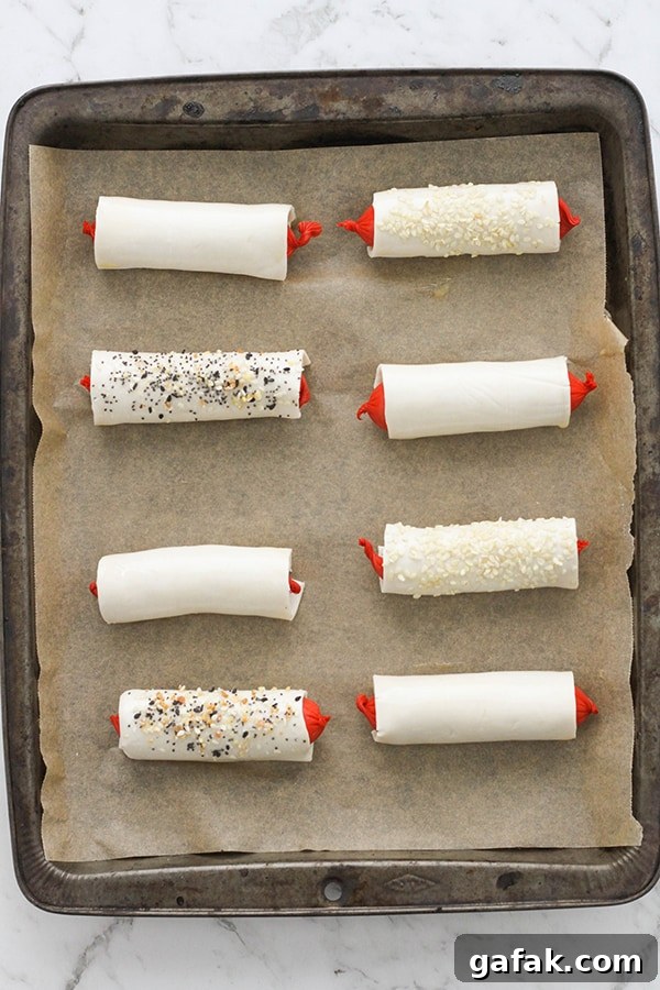 puffy dogs on a baking tray ready to be cooked.