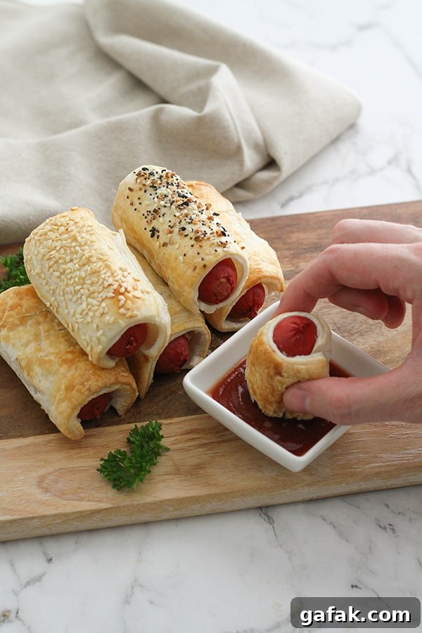 puffy dogs stacked on a wooden serving board.