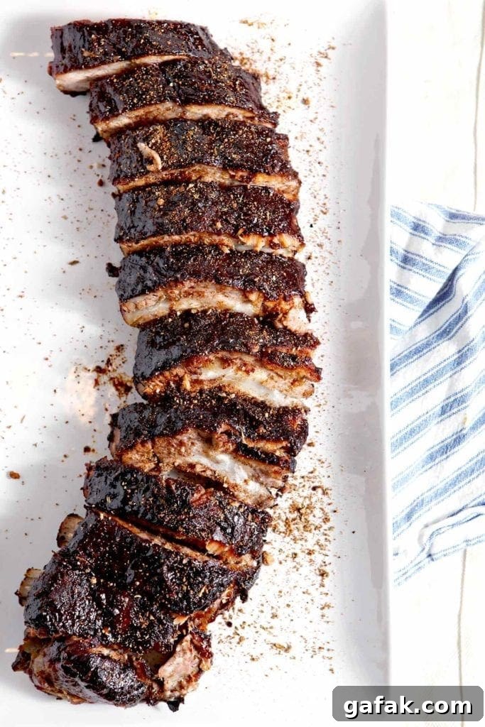Sliced oven baked ribs recipe sprinkled with barbecue dry rub