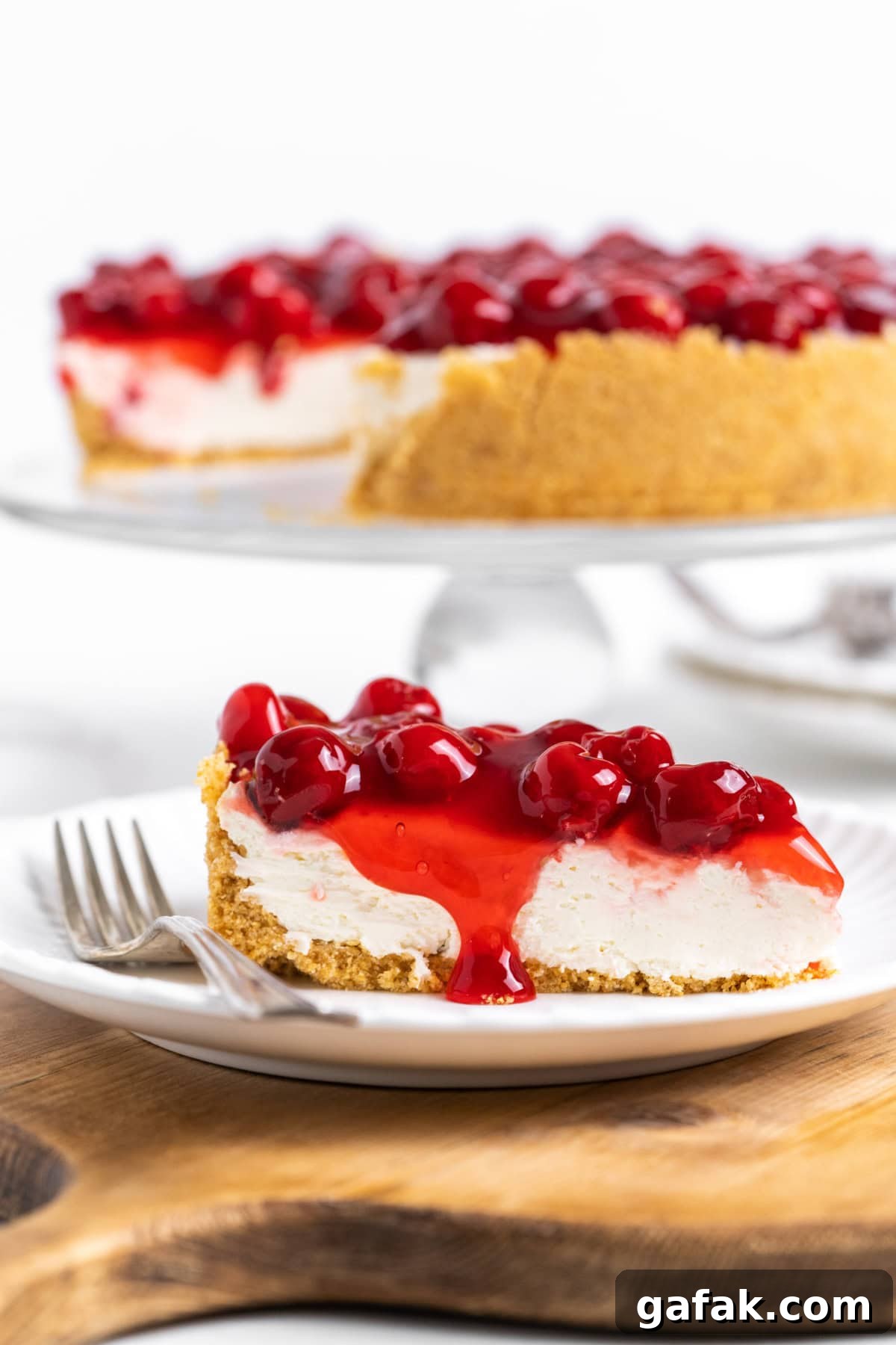 slice of no bake cherry cheesecake on plate with fork