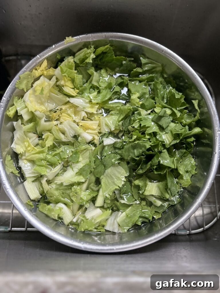Rinsing greens in bowl with cold water.