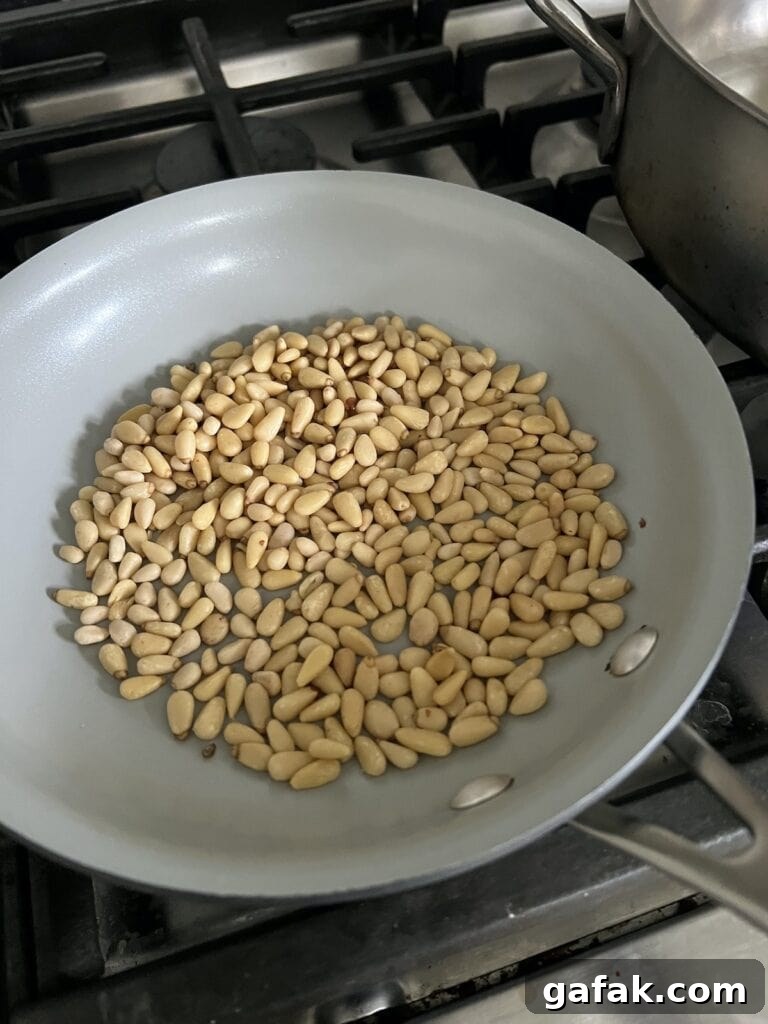 Toasting pine nuts in small pan.