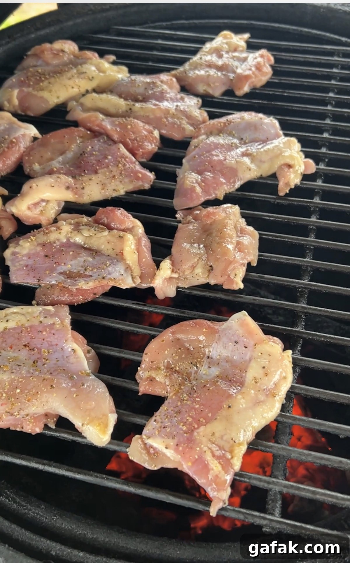 Chicken thighs on a grill.