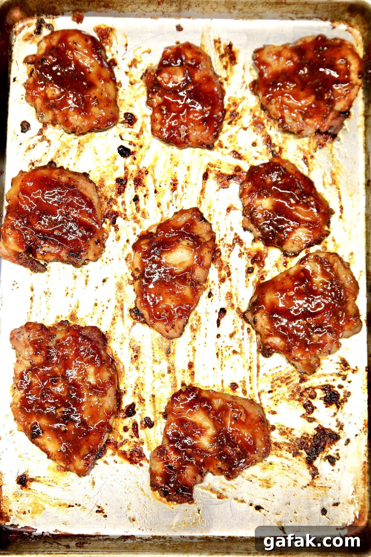 BBQ chicken thighs on a sheet pan.