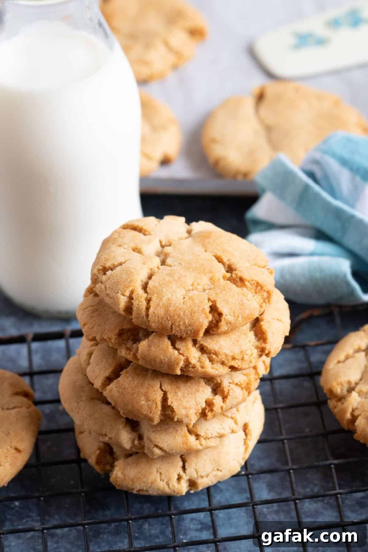 Ginger biscuits stacked on a cooling rack.