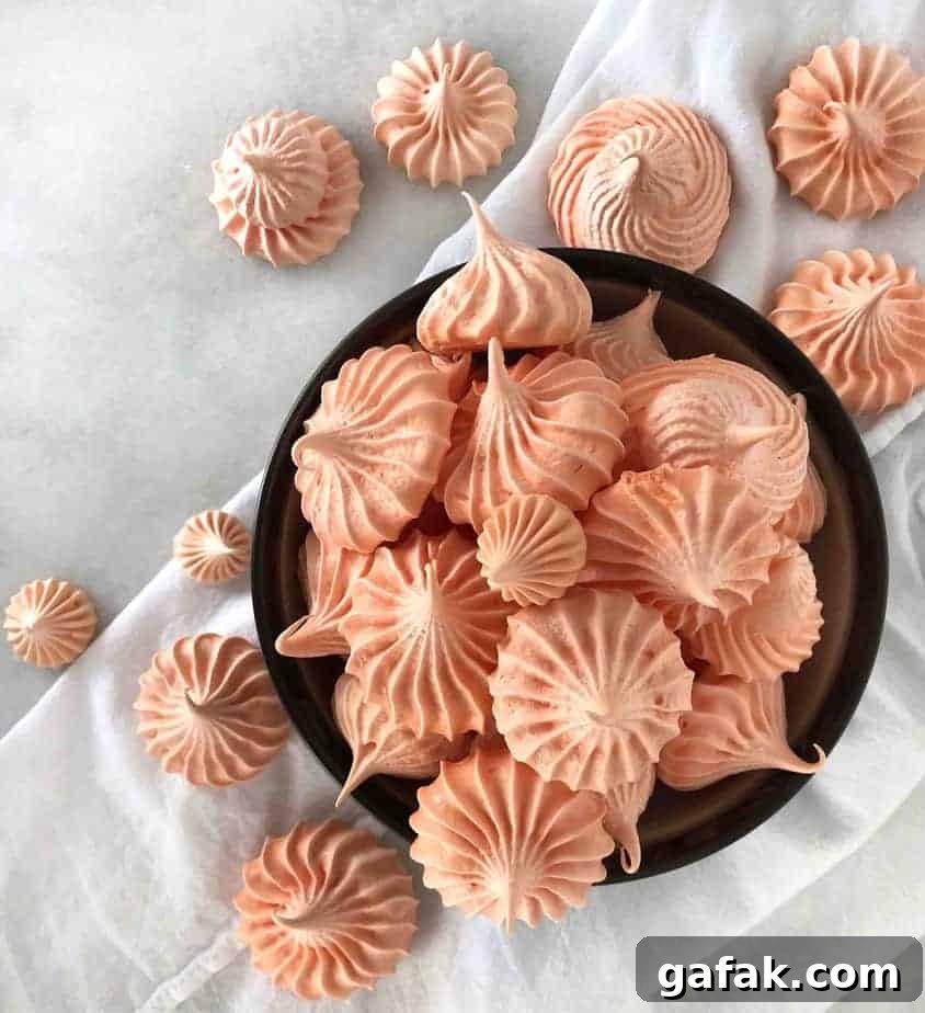 Crisp Pumpkin Spice Meringue Cookies — Light Fall Dessert 4 overhead shot of meringue cookies in bowl and scattered over dish cloth