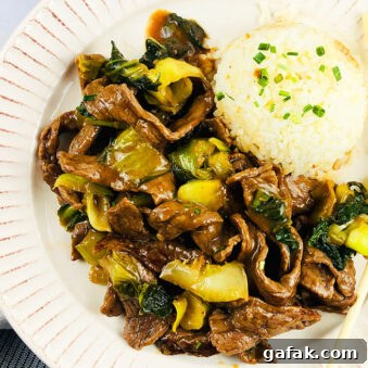 Easy Instant Pot Ginger Beef Served in White Plate With Steamed Rice- Overhead Shot