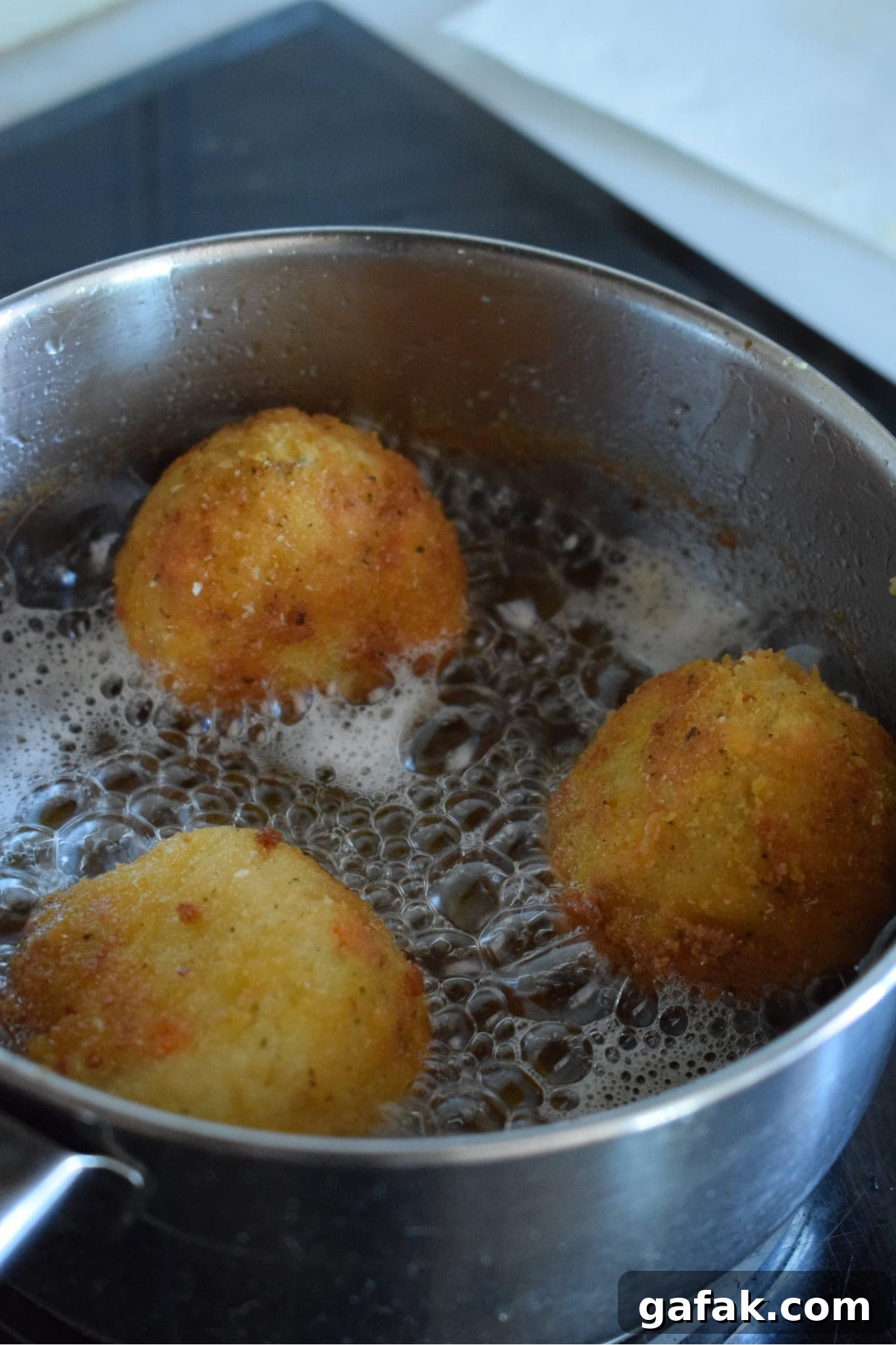 Frying arancini in oil