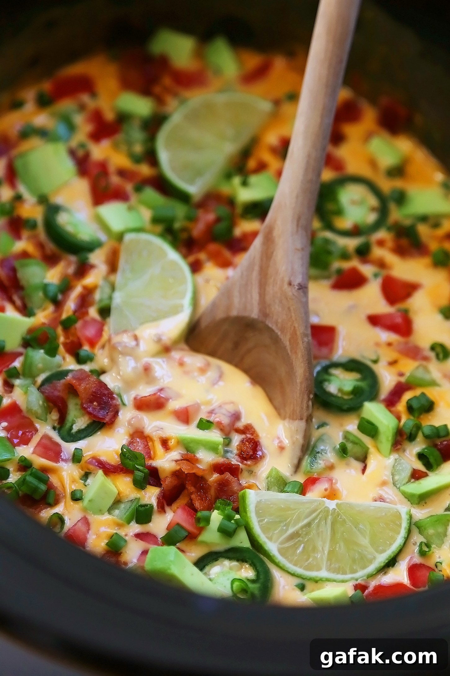 Creamy 2-Ingredient Slow Cooker Queso Dip for Parties 5 2-Ingredient CrockPot Queso Dip - So easy, cheesy and full of flavor for parties and lazy weekends in. Load it up with bacon, tomatoes, jalapenos and your favorite fixin's!