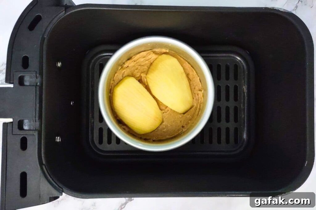 place filled apple cake pans in air fryer basket