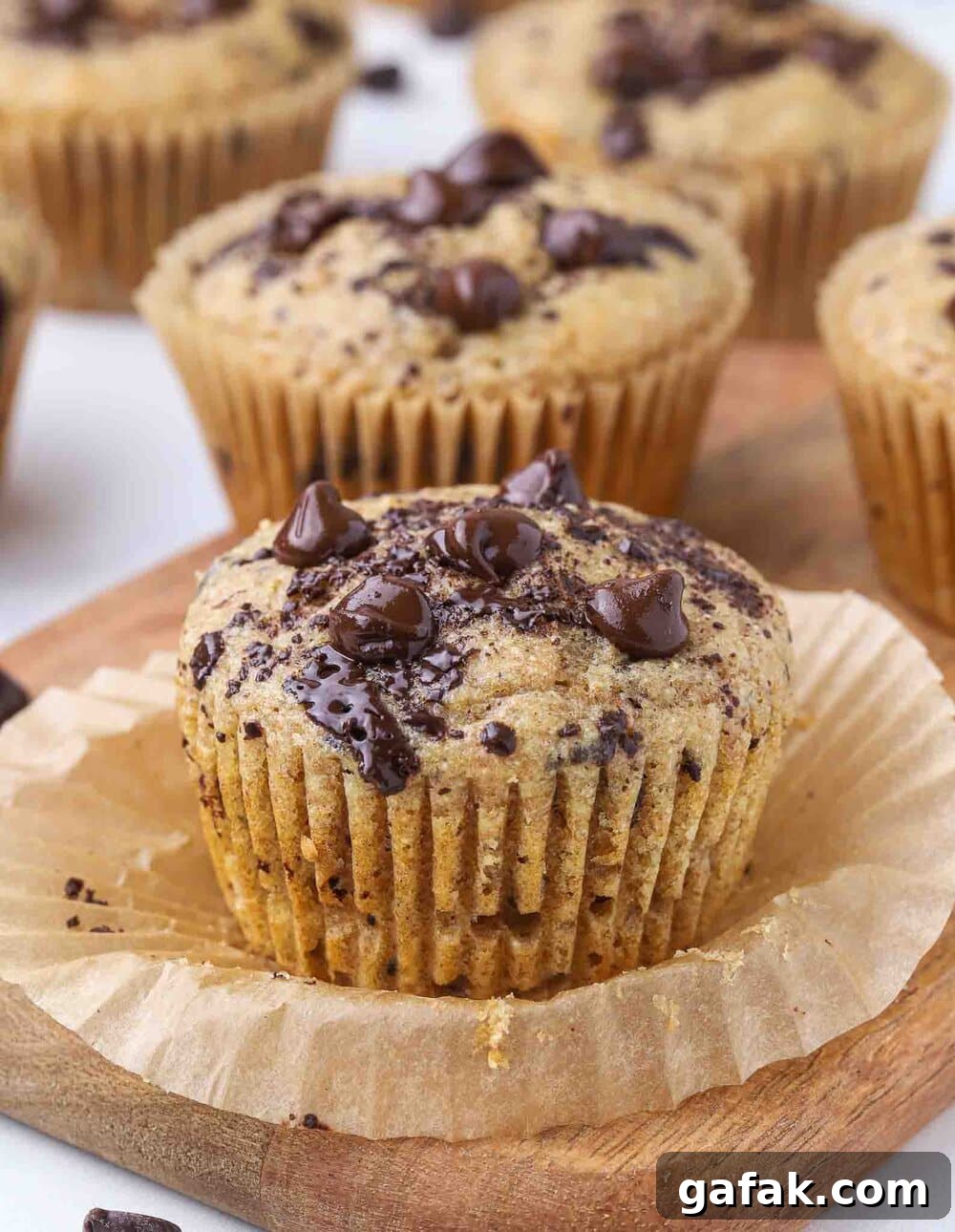 Chocolate chip muffins on a cutting board.