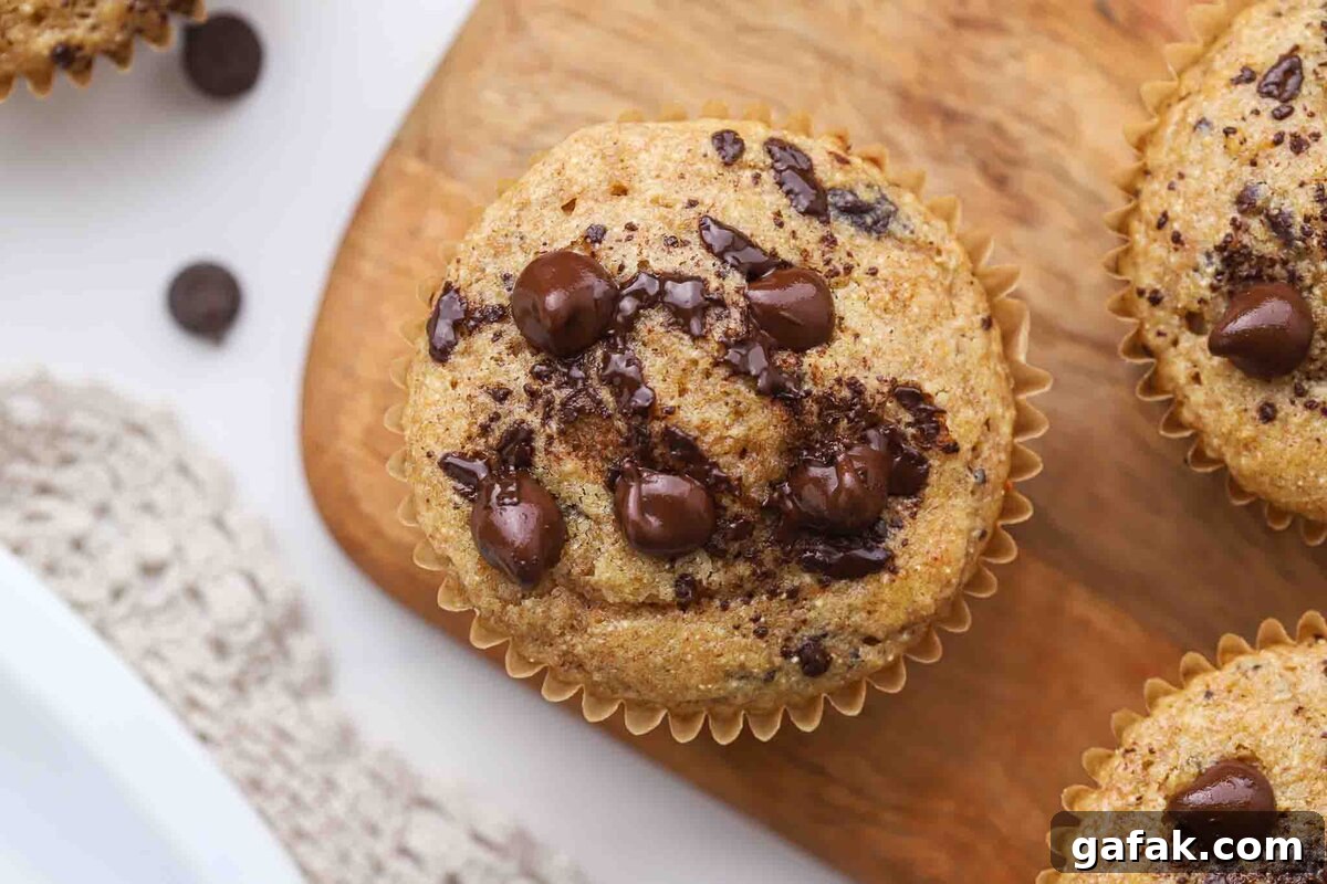 Chocolate chip muffin on a board.