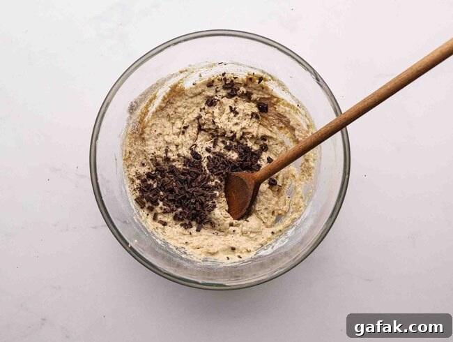 Stirring chocolate chip muffin batter.