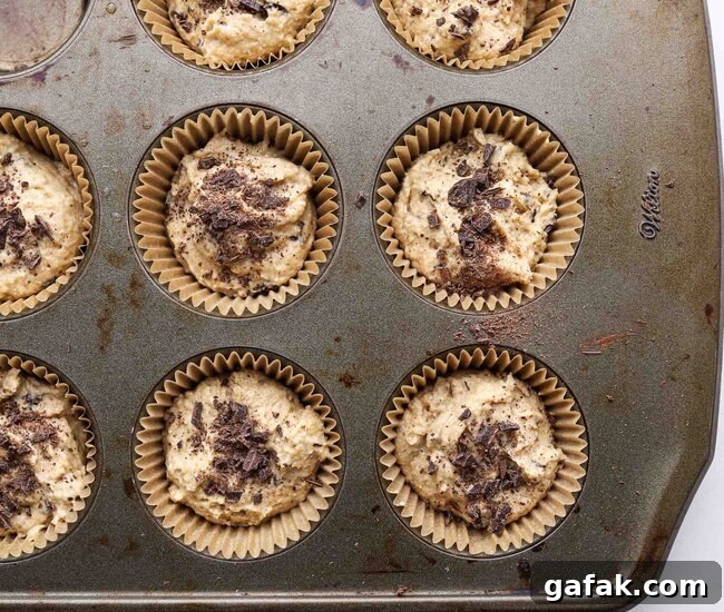 Unbaked muffins in a muffin tin.