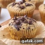 Chocolate chip muffins on a cutting board.