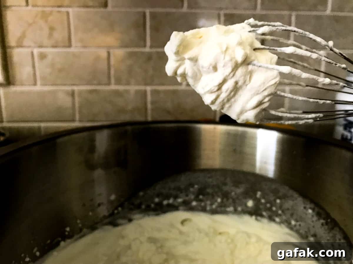Whipped cream on a metal whisk 