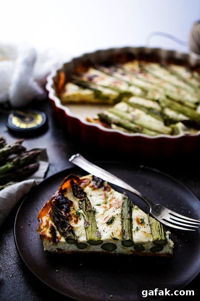 A Slice of Quiche on a Wooden Plate with a Fork Next to the Pie Pan