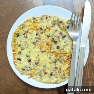 Mushroom omelette in air fryer served on a white plate.