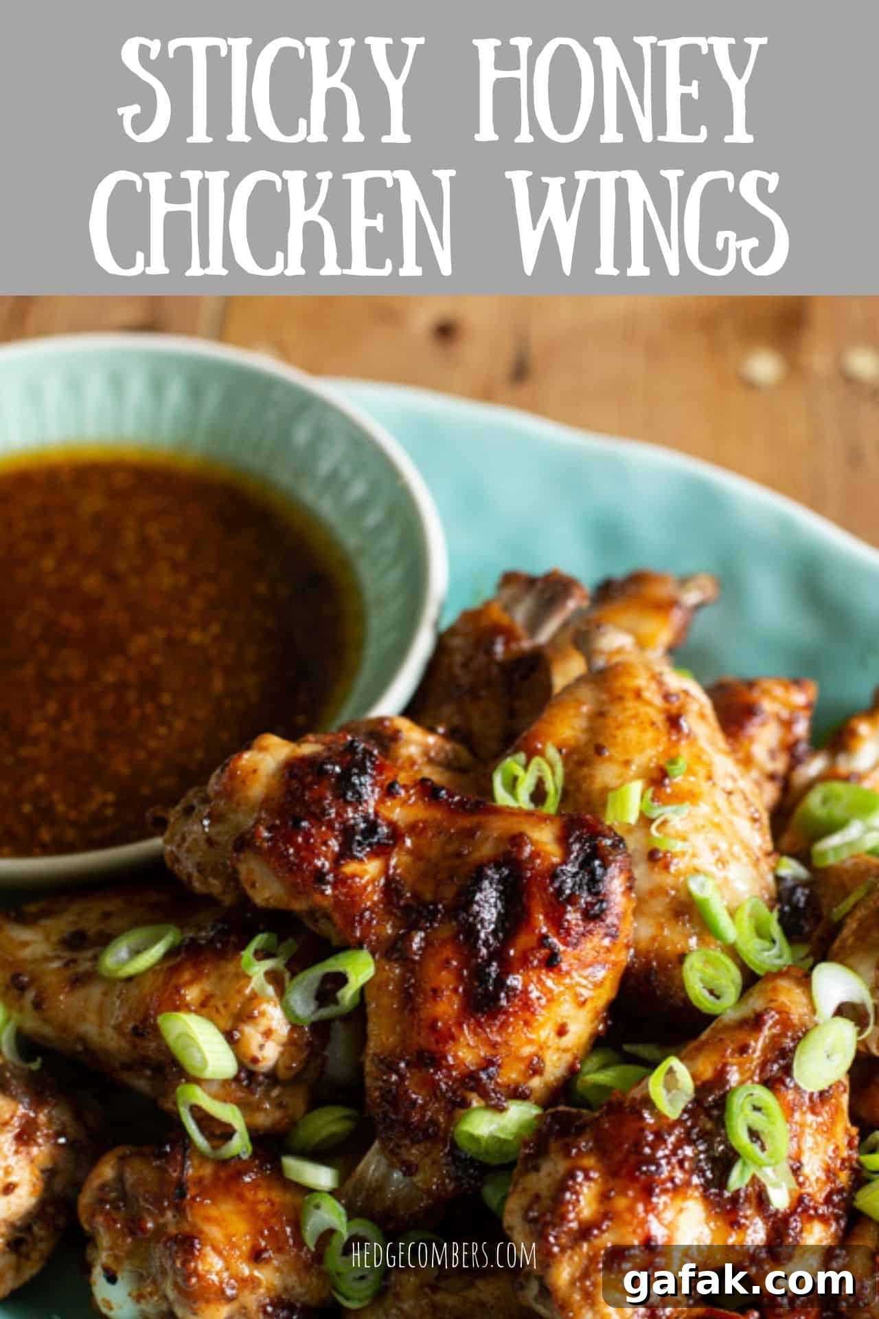 Sticky Honey Chicken Wings Recipe: Crispy Baked or Fried Wings 2 blue plate with dipping bowl of brown sauce and a pile of golden brown chicken wings