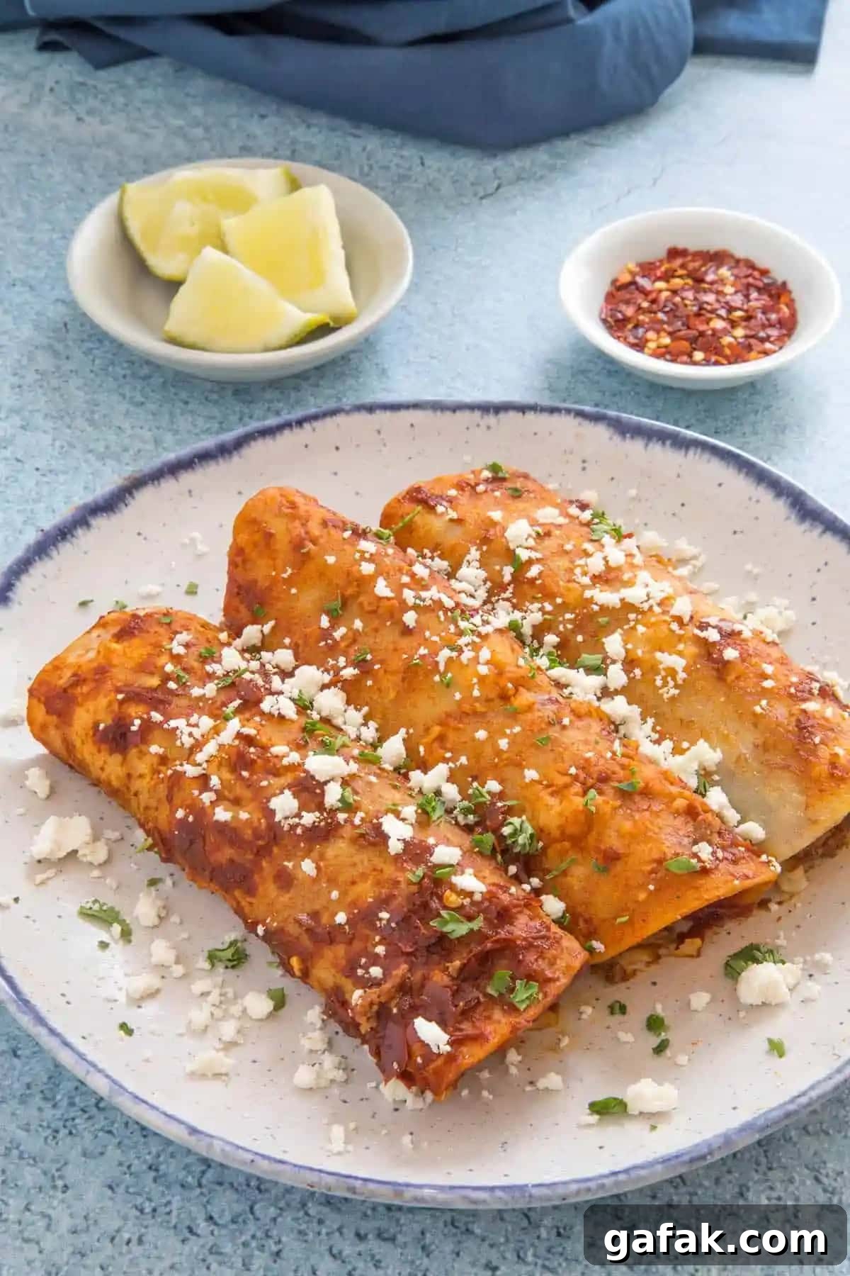 Beef enchiladas on a plate.