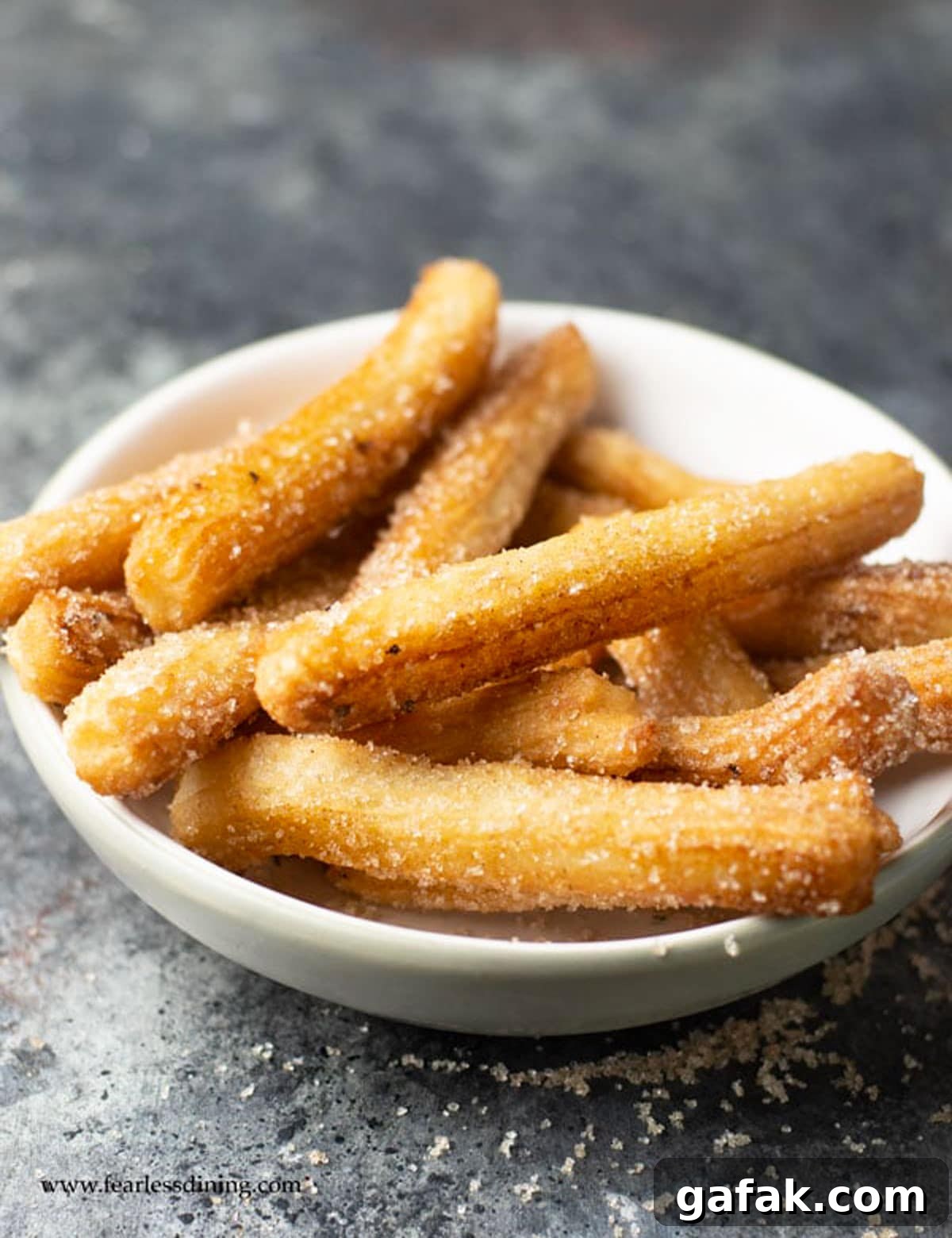 A big bowl full of fried churros.