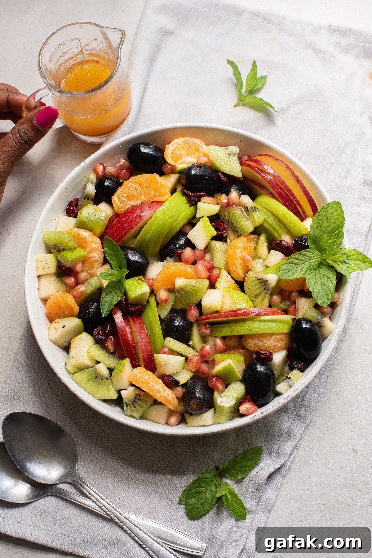 Bowl of fruit with dressing.