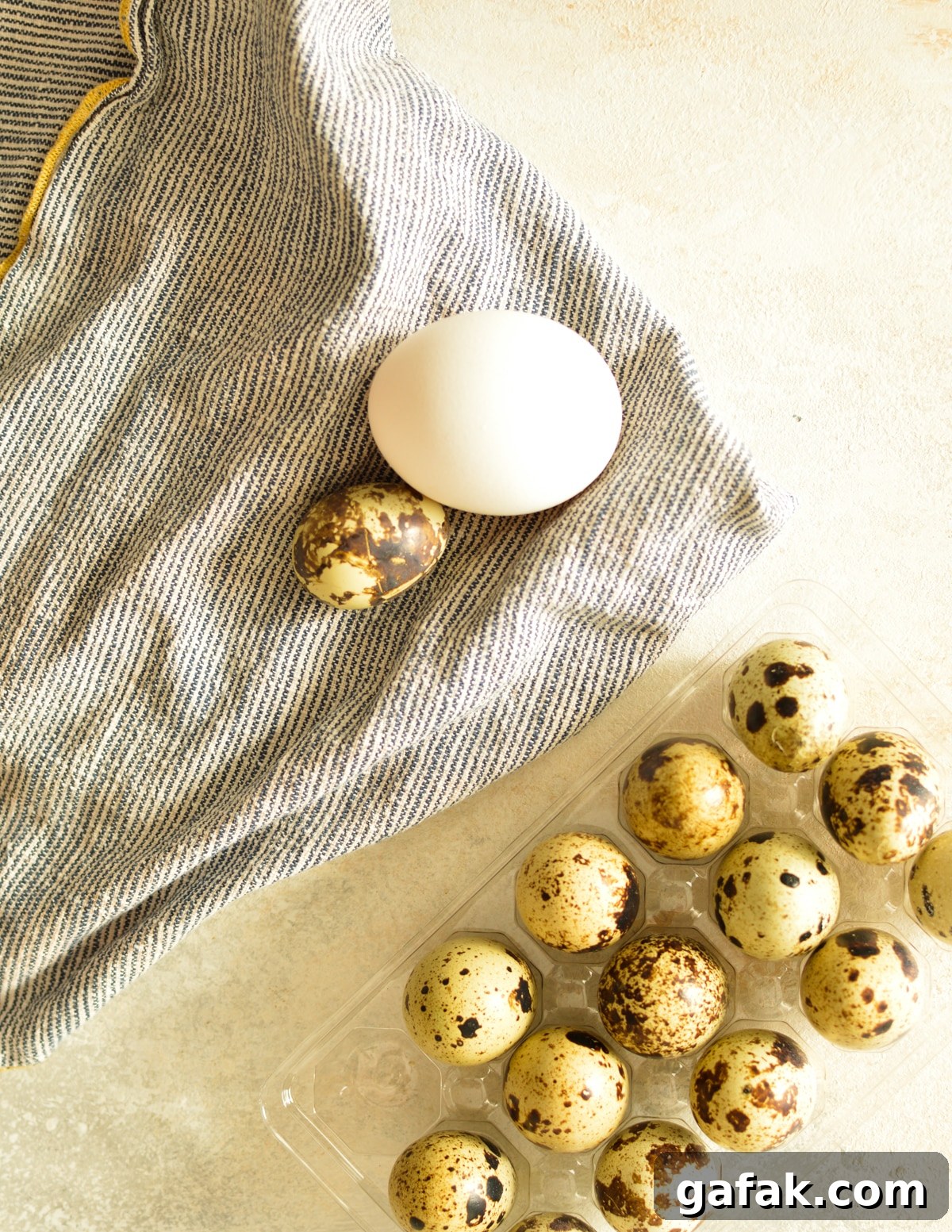 a chicken egg next to quail eggs