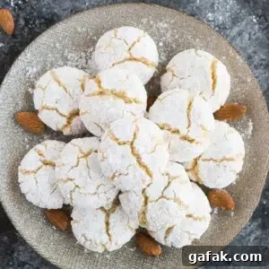 amaretti cookies on a plate with raw almonds