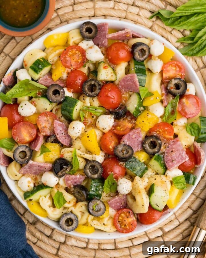 A bowl of tortellini pasta salad ready to serve on the table.