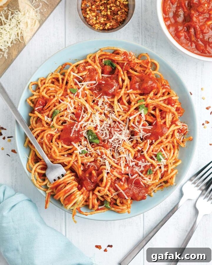 Bowl of spaghetti arrabiata with a fork twisted with pasta.