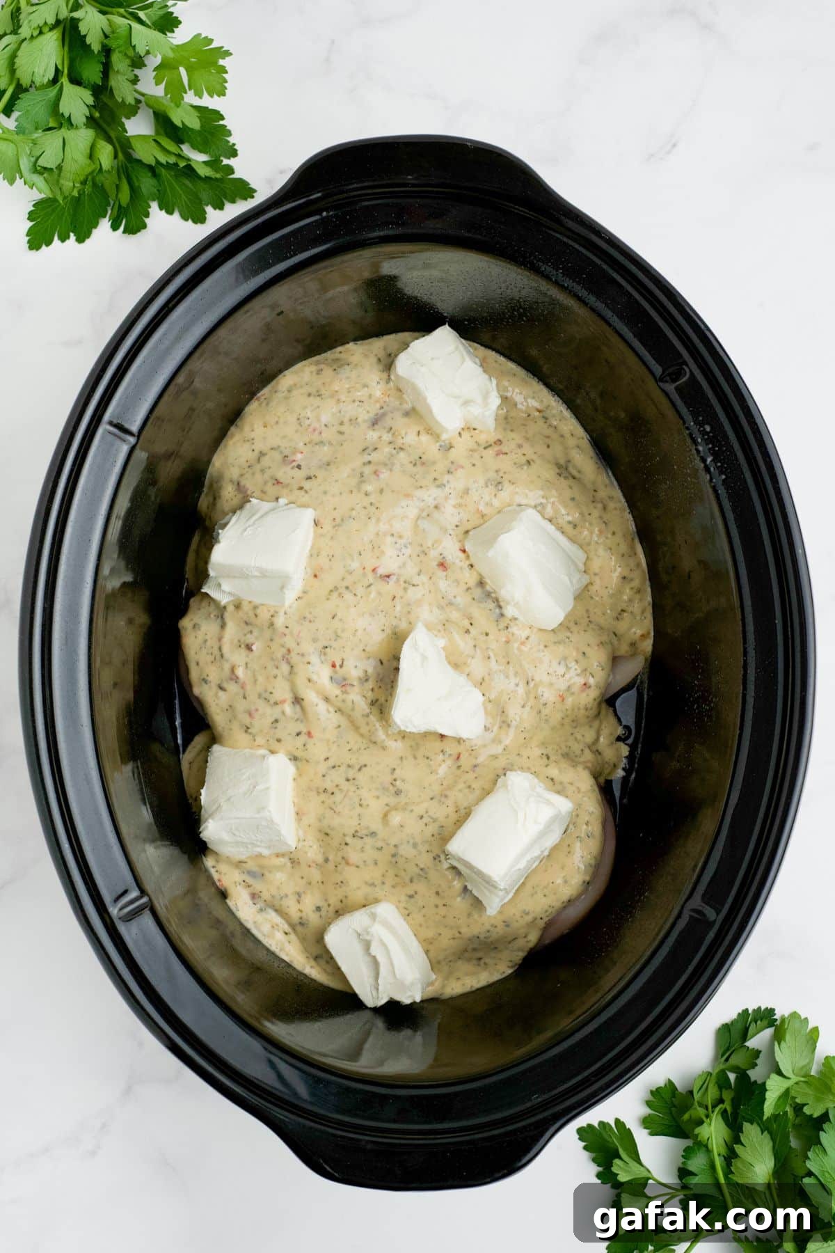Garlic Parmesan Chicken Pasta in the Crockpot — Creamy Slow-Cooker Recipe 5 Sauce and cream cheese added on top of the chicken.