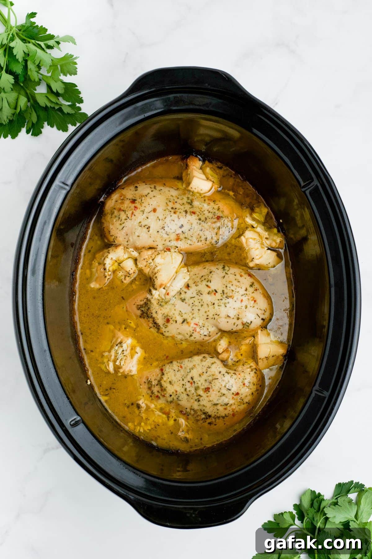 Garlic Parmesan Chicken Pasta in the Crockpot — Creamy Slow-Cooker Recipe 6 Cooked chicken in juices in the slow cooker.