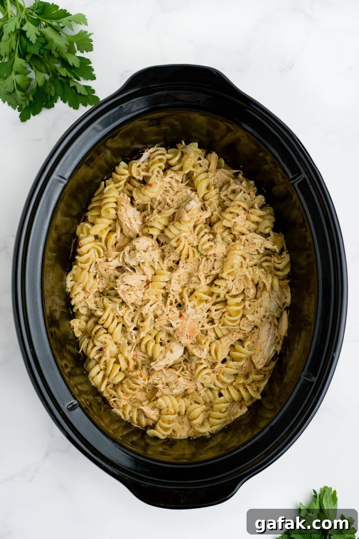 Garlic Parmesan Chicken Pasta in the Crockpot — Creamy Slow-Cooker Recipe 9 Pasta stirred into the chicken and sauce.