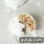 Single serve snowball cookie made with chopped pecans and rolled in powdered sugar.