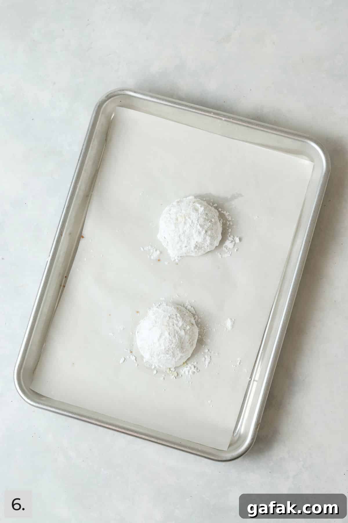 Finished snowball cookies rolled in powdered sugar.