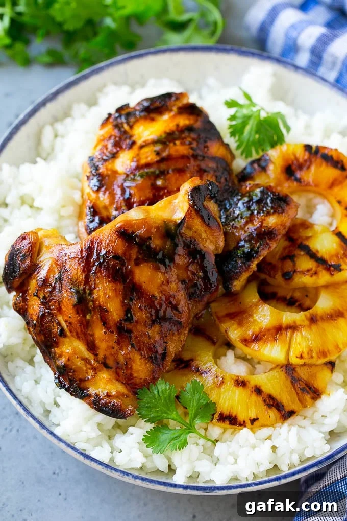 Hawaiian chicken thighs and grilled pineapple served over rice. Hawaiian chicken thighs and grilled pineapple served over rice.