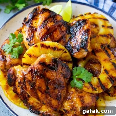 Hawaiian Grilled Chicken with Pineapple Glaze Recipe 2 A plate of Hawaiian chicken with grilled pineapple.