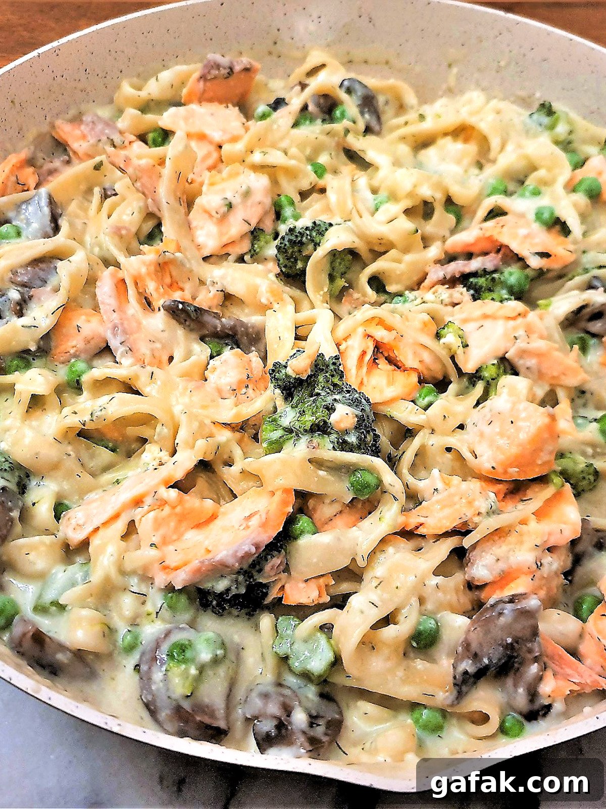 Salmon and broccoli pasta in a frying pqn.