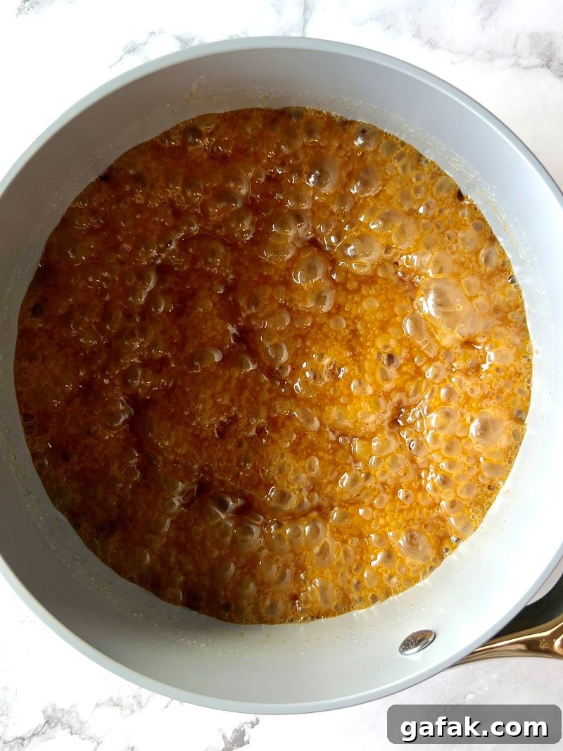 sweet and spicy glaze ingredients combined in a small saucepan. Butter, brown sugar, corn syrup, and spices. 