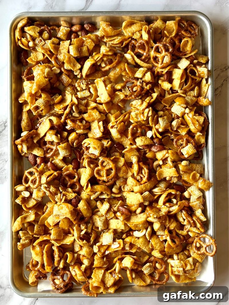 Glaze mixed with crunchy ingredients and spread on a sheet pan.