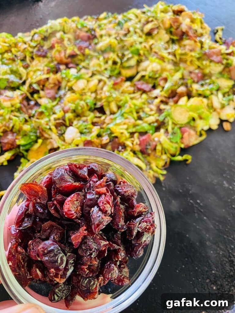 adding dried cranberries to Blackstone Bacon Cranberry Brussel Sprouts