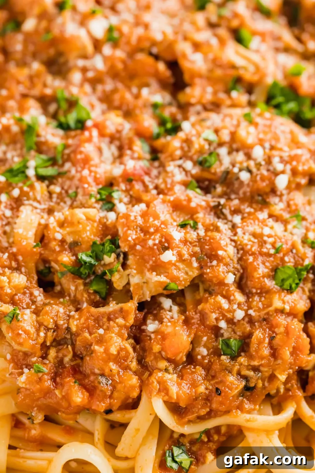 A close up image of red clam sauce on linguine.