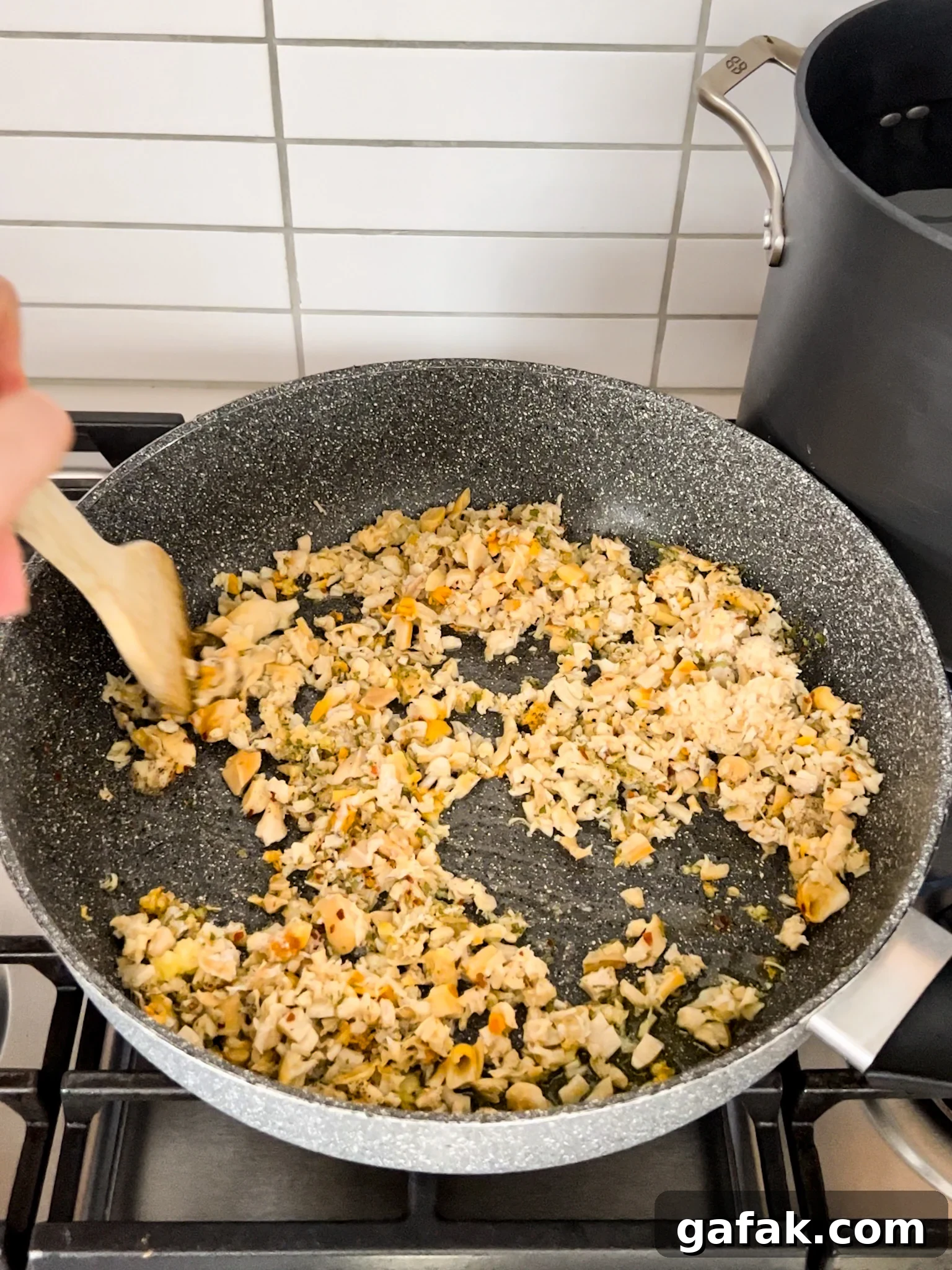 A pan with clams sautéing in it.