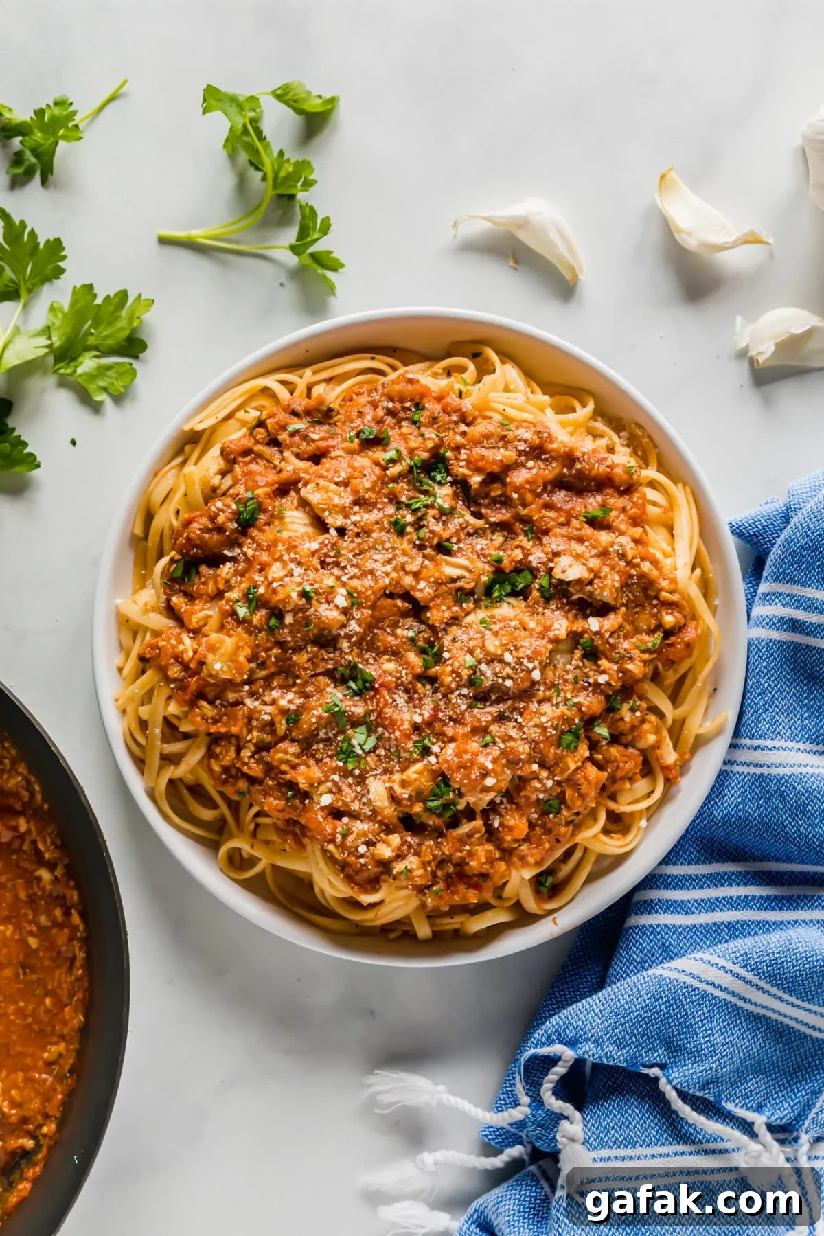 An overhead image of a bowl of linguine with clam sauce.